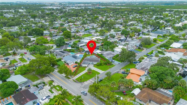 an aerial view of residential houses with outdoor space and trees