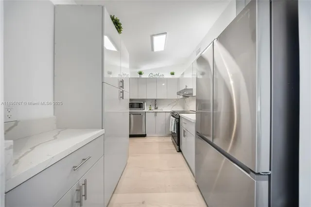 a kitchen with cabinets and stainless steel appliances