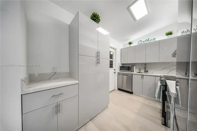 a kitchen with a sink stainless steel appliances and cabinets