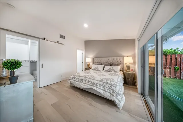 a bedroom with a bed and a potted plant