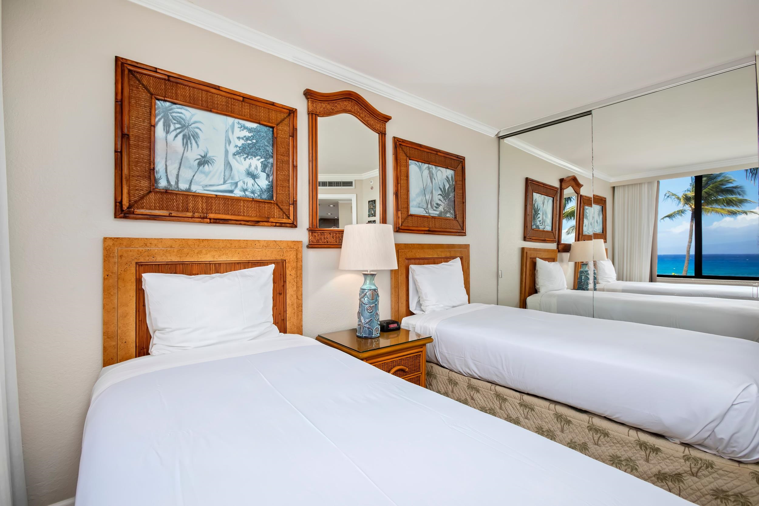 3445 Lower Honoapiilani Road, Unit 304 Lahaina, HI 96761 - Photo 15 of 41 a bedroom with a large bed and a painting on the wall