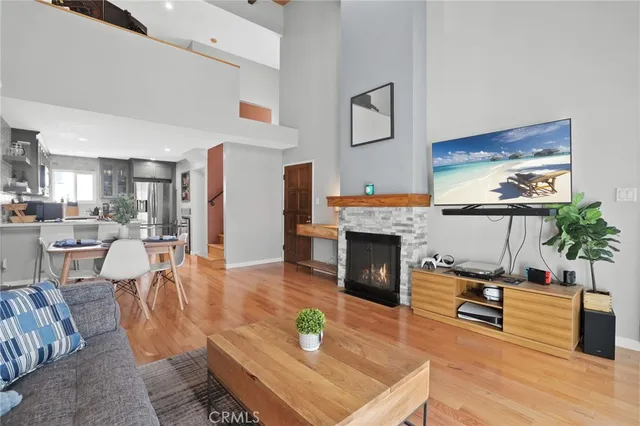 a living room with furniture a fireplace and a flat screen tv