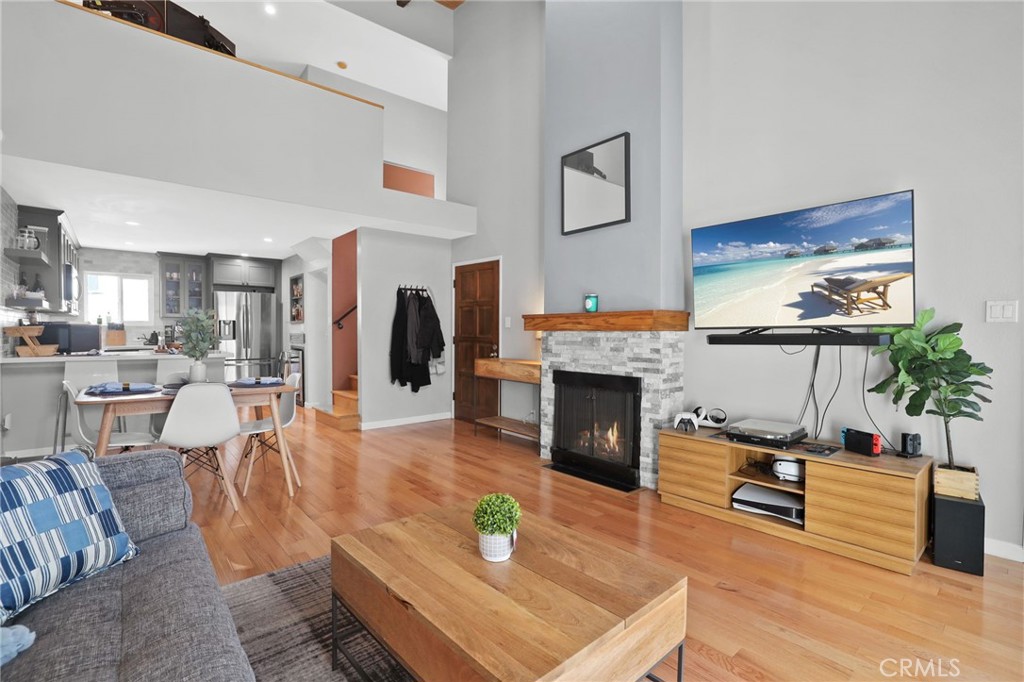 11954 Goshen Avenue, Unit 205 Los Angeles, CA 90049 - Photo 13 of 48 a living room with furniture a fireplace and kitchen view