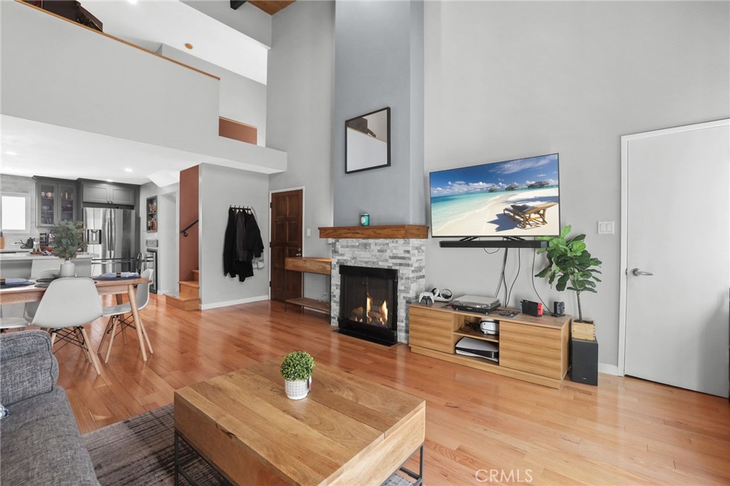 11954 Goshen Avenue, Unit 205 Los Angeles, CA 90049 - Photo 14 of 48 a living room with furniture a fireplace and a flat screen tv