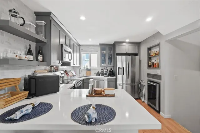 a kitchen with refrigerator and cabinets