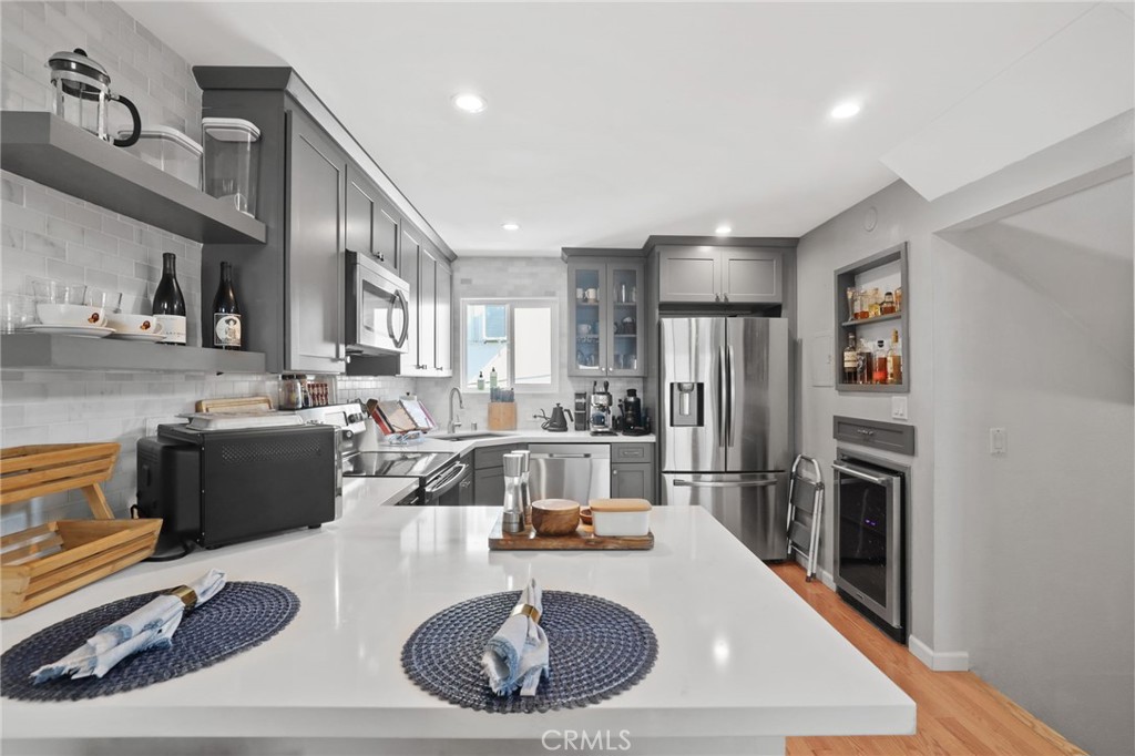 11954 Goshen Avenue, Unit 205 Los Angeles, CA 90049 - Photo 20 of 48 a kitchen with refrigerator and cabinets