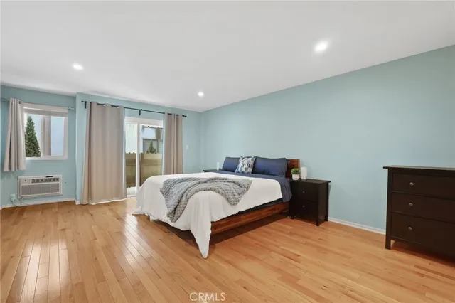 a spacious bedroom with a bed and a dresser