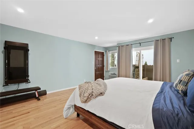 a spacious bedroom with a bed and a dresser