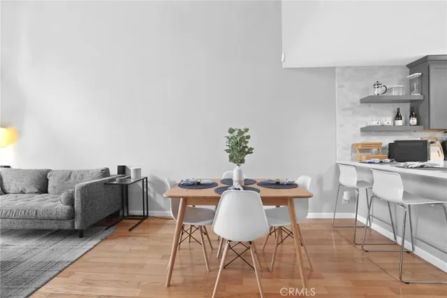 a living room with furniture and a kitchen area