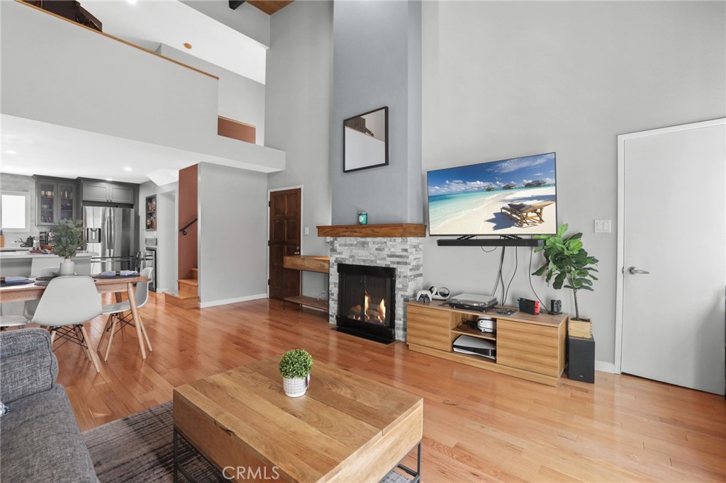 11954 Goshen Avenue, Unit 205 Los Angeles, CA 90049 - Photo 45 of 48 a living room with furniture a fireplace and a flat screen tv