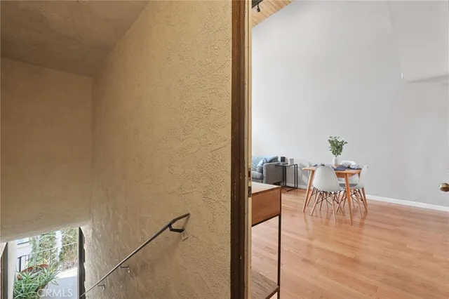a dining room with furniture and wooden floor