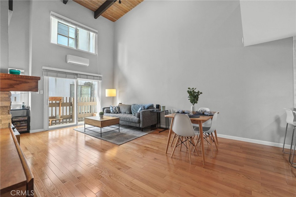 11954 Goshen Avenue, Unit 205 Los Angeles, CA 90049 - Photo 9 of 48 a living room with furniture a wooden floor and a potted plant