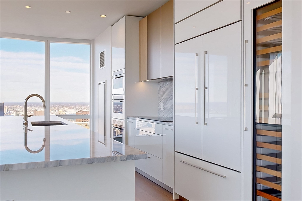 240 Devonshire Street, Unit 5701 Boston, MA 02110 - Photo 4 of 41 a kitchen with stainless steel appliances granite countertop a refrigerator and a sink