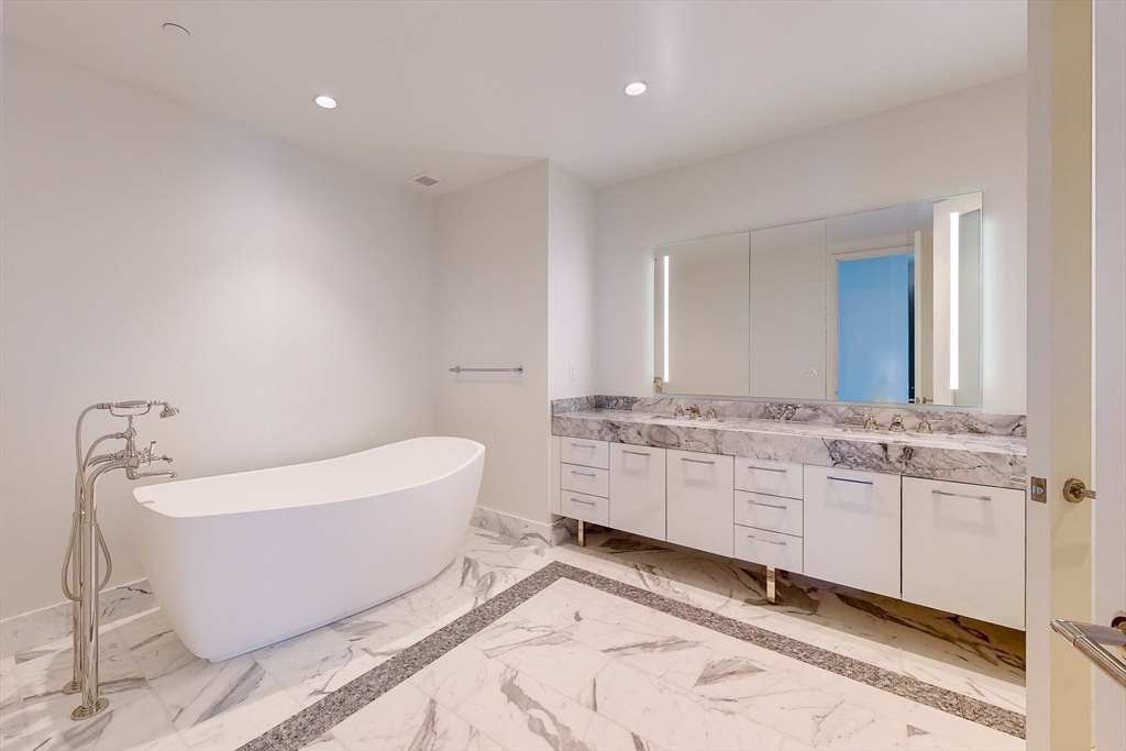 240 Devonshire Street, Unit 5701 Boston, MA 02110 - Photo 8 of 41 a bathroom with a bathtub sink double and mirror