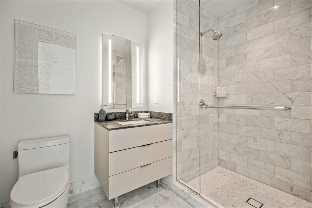 240 Devonshire Street, Unit 5701 Boston, MA 02110 - Photo 10 of 41 a bathroom with a sink a toilet and shower