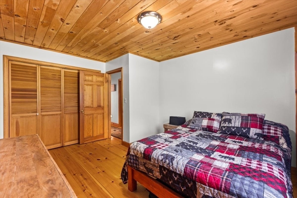 148 Braley Hill Road Rochester, MA 02770 - Photo 24 of 41 a bedroom with a bed and a window