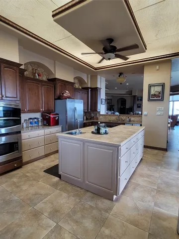 a kitchen with stainless steel appliances granite countertop a stove and a refrigerator