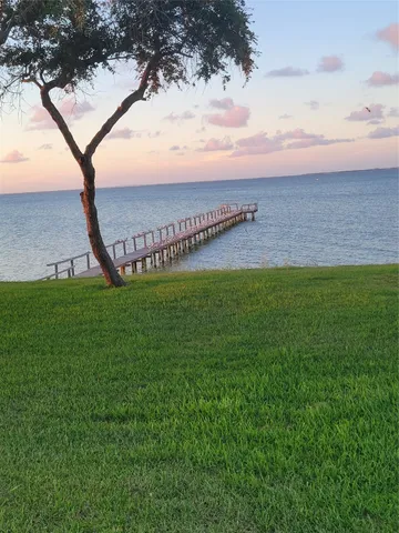 a view of a room with gym equipment and a flat screen tv