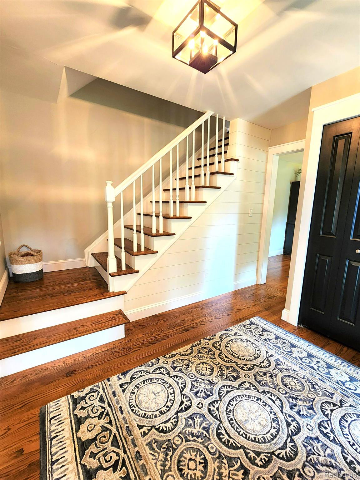 Grand foyer, wood floors, wooden staircase. 
