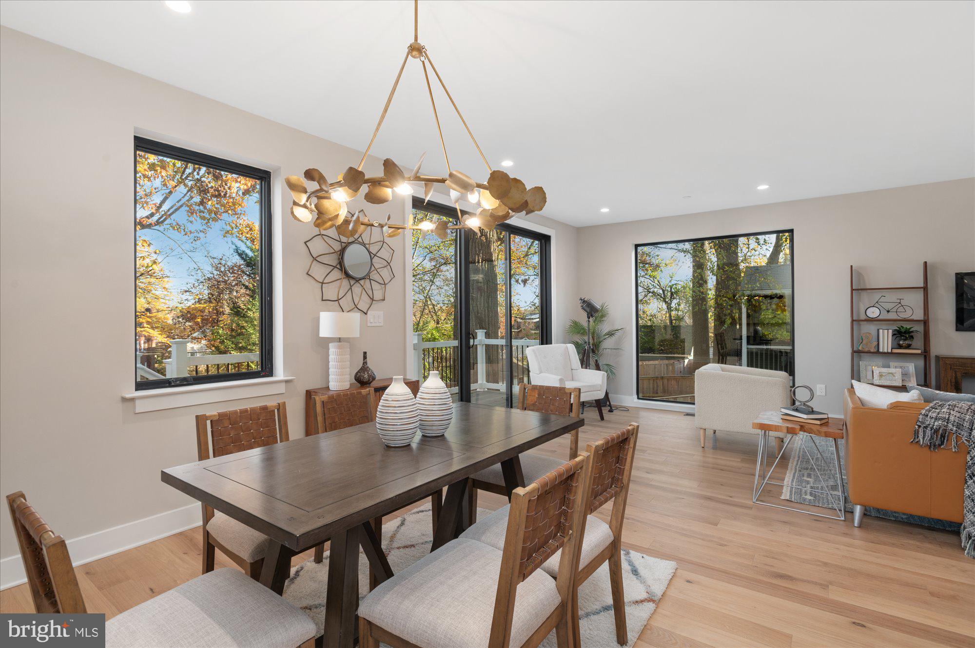 5445 33rd Street Northwest Washington, DC 20015 - Photo 21 of 72 a dining room with furniture a chandelier and wooden floor