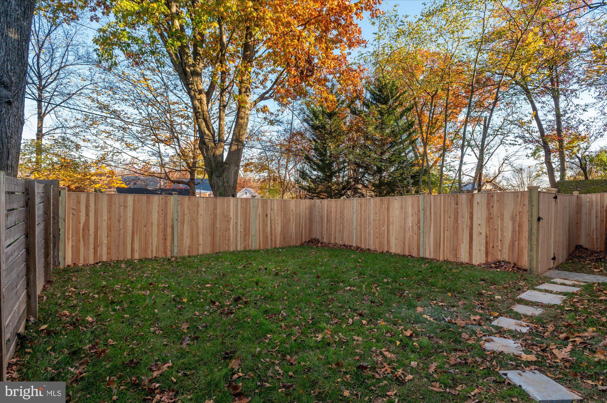 5445 33rd Street Northwest Washington, DC 20015 - Photo 64 of 72 a view of a backyard with large trees and wooden fence