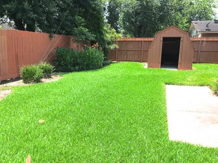 a view of a house with a yard and sitting area