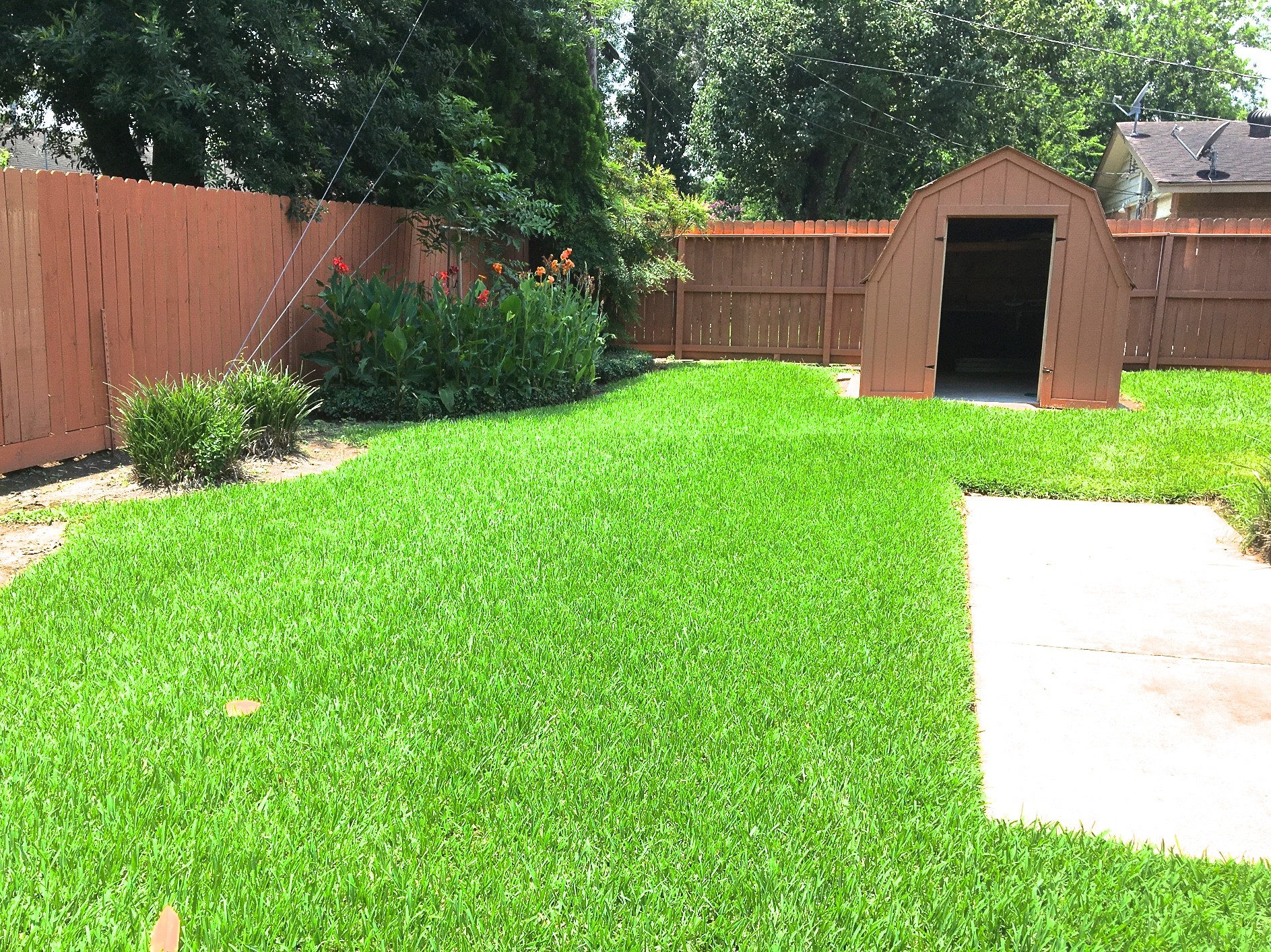9307 Val Verde Street Houston, TX 77063 - Photo 15 of 17 a view of a backyard with potted plants and wooden fence