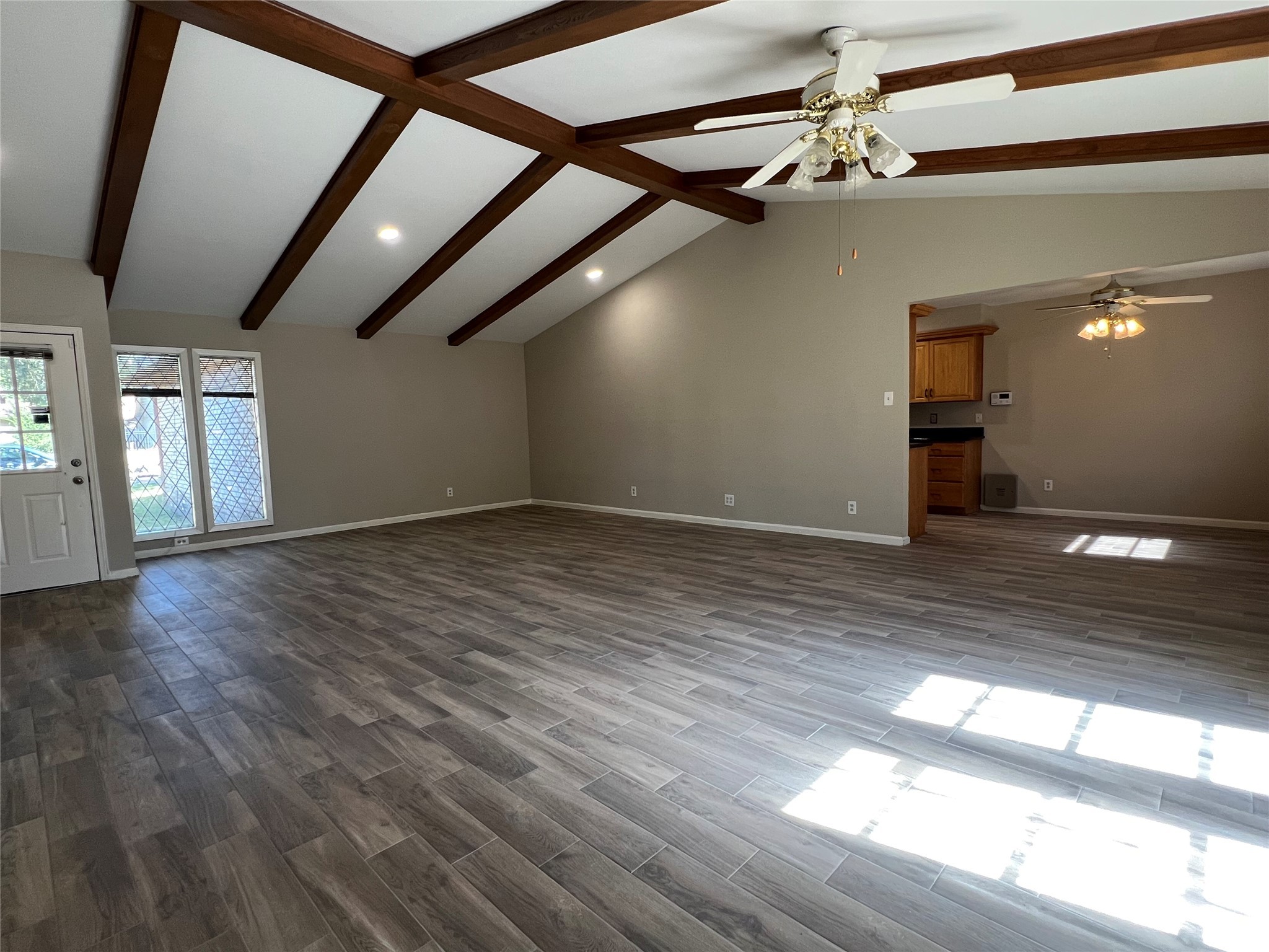 9307 Val Verde Street Houston, TX 77063 - Photo 3 of 17 a view of an empty room with wooden floor and a window