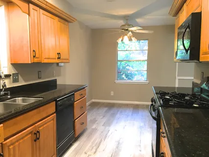 a kitchen that has a sink and a stove