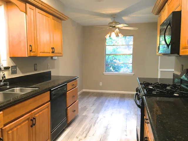 a kitchen that has a sink and a stove