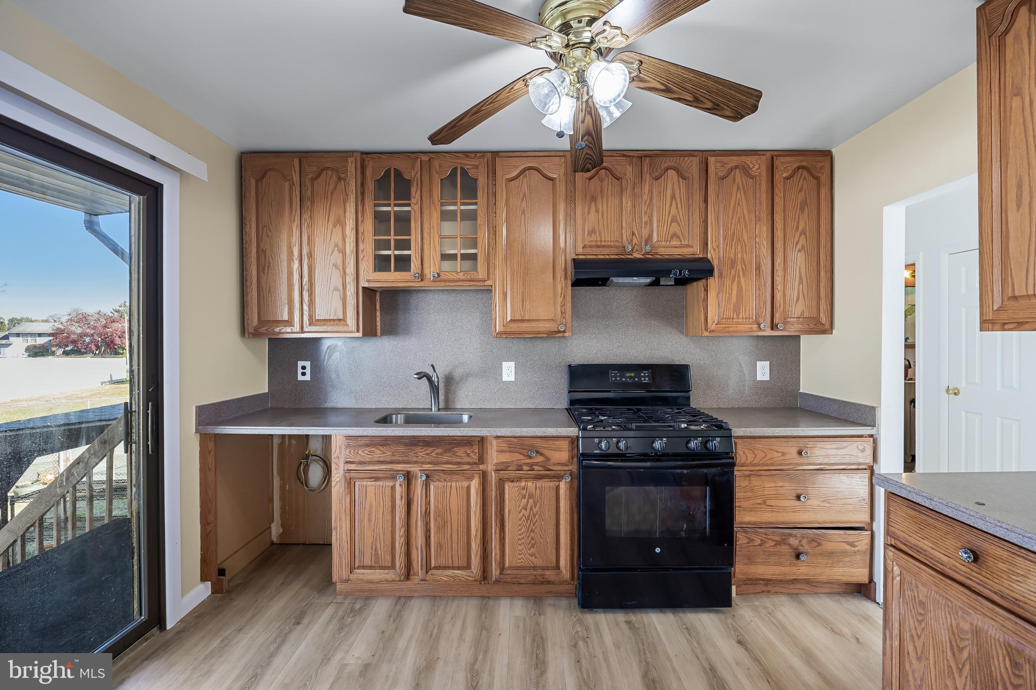 227 University Avenue Pemberton, NJ 08068 - Photo 9 of 33 a kitchen with a stove window and cabinets