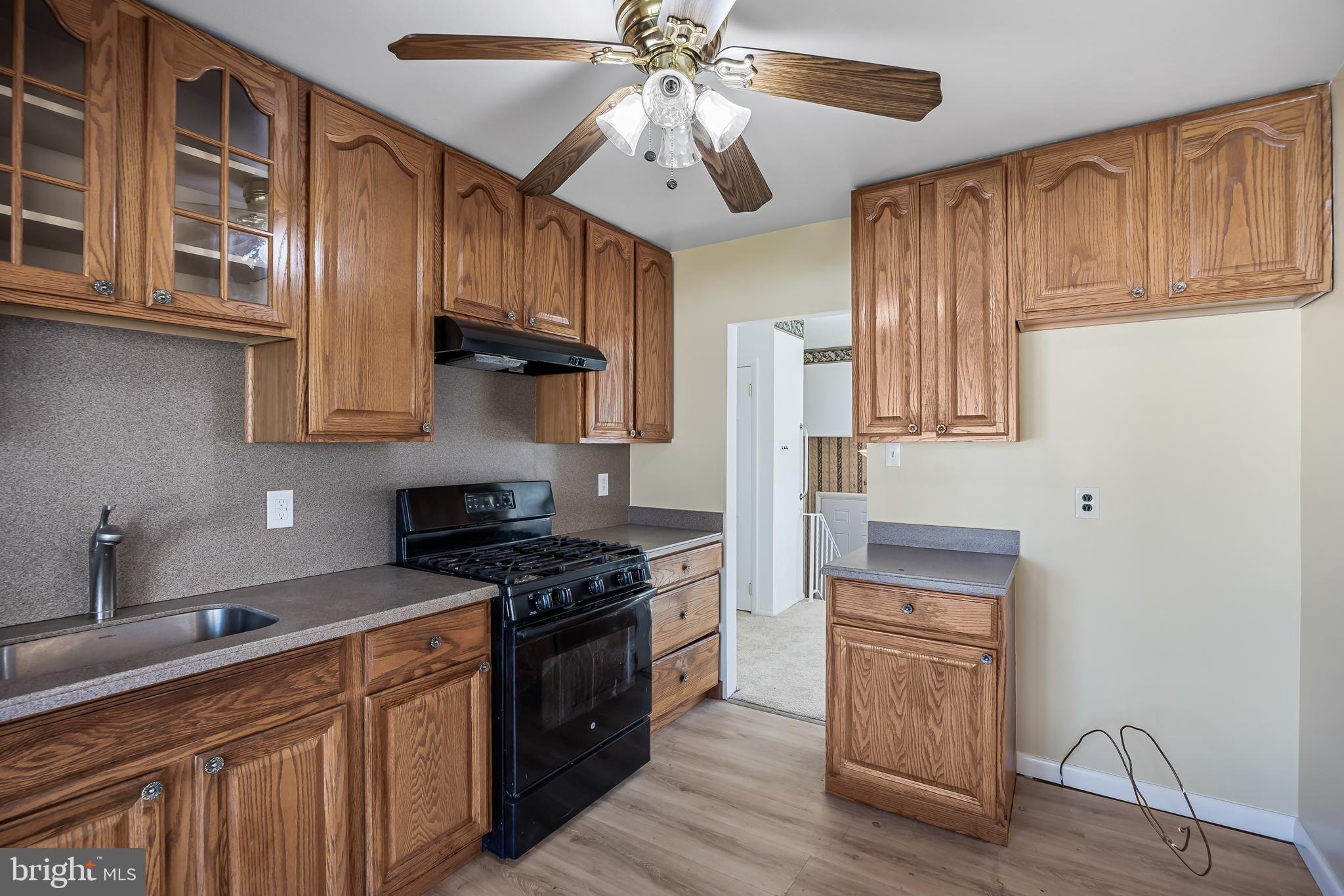 227 University Avenue Pemberton, NJ 08068 - Photo 10 of 33 a kitchen with stainless steel appliances granite countertop a stove a sink dishwasher and a refrigerator with wooden cabinets