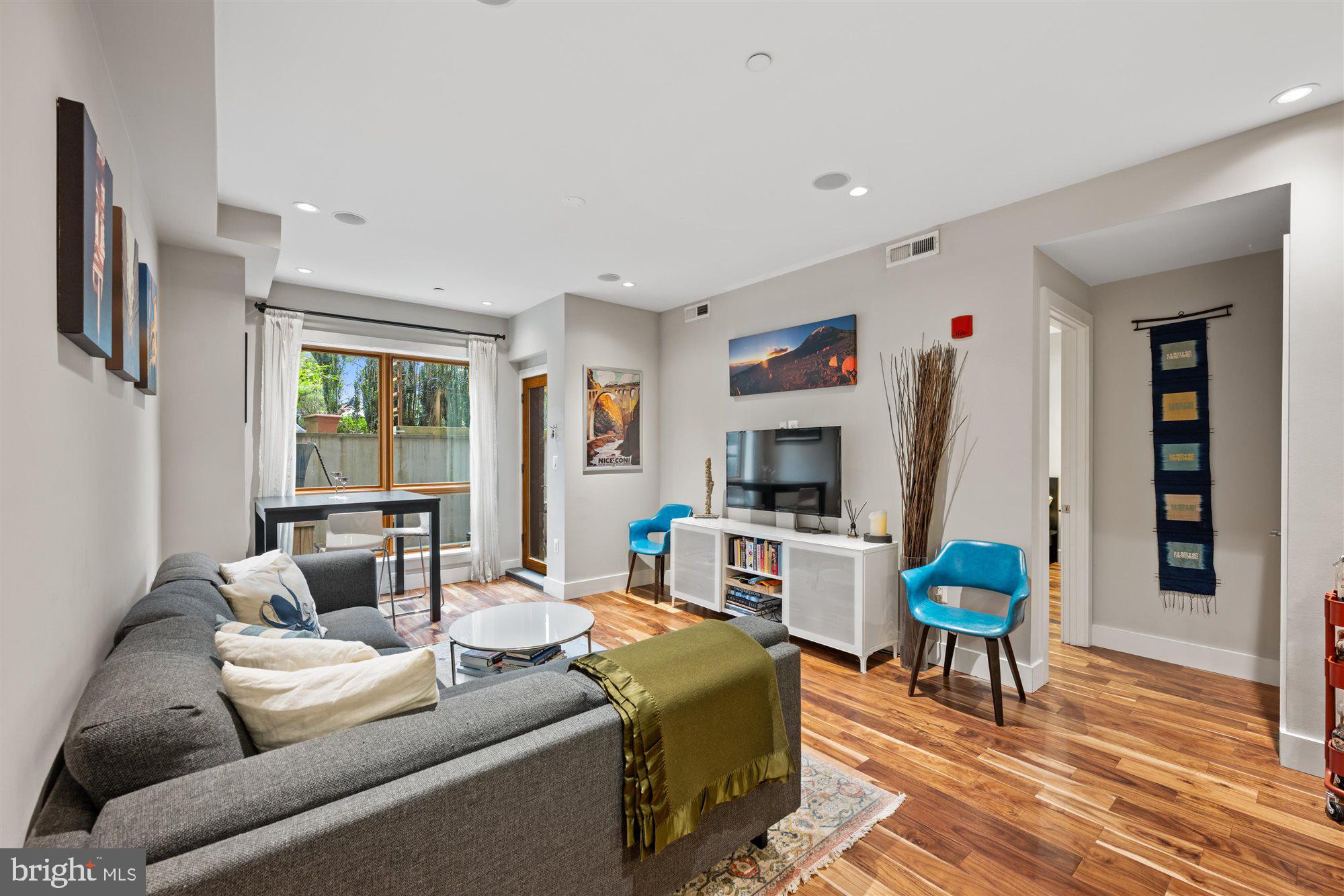 1337 K Street Southeast, Unit 101 Washington, DC 20003 - Photo 2 of 12 a living room with furniture a flat screen tv and a table