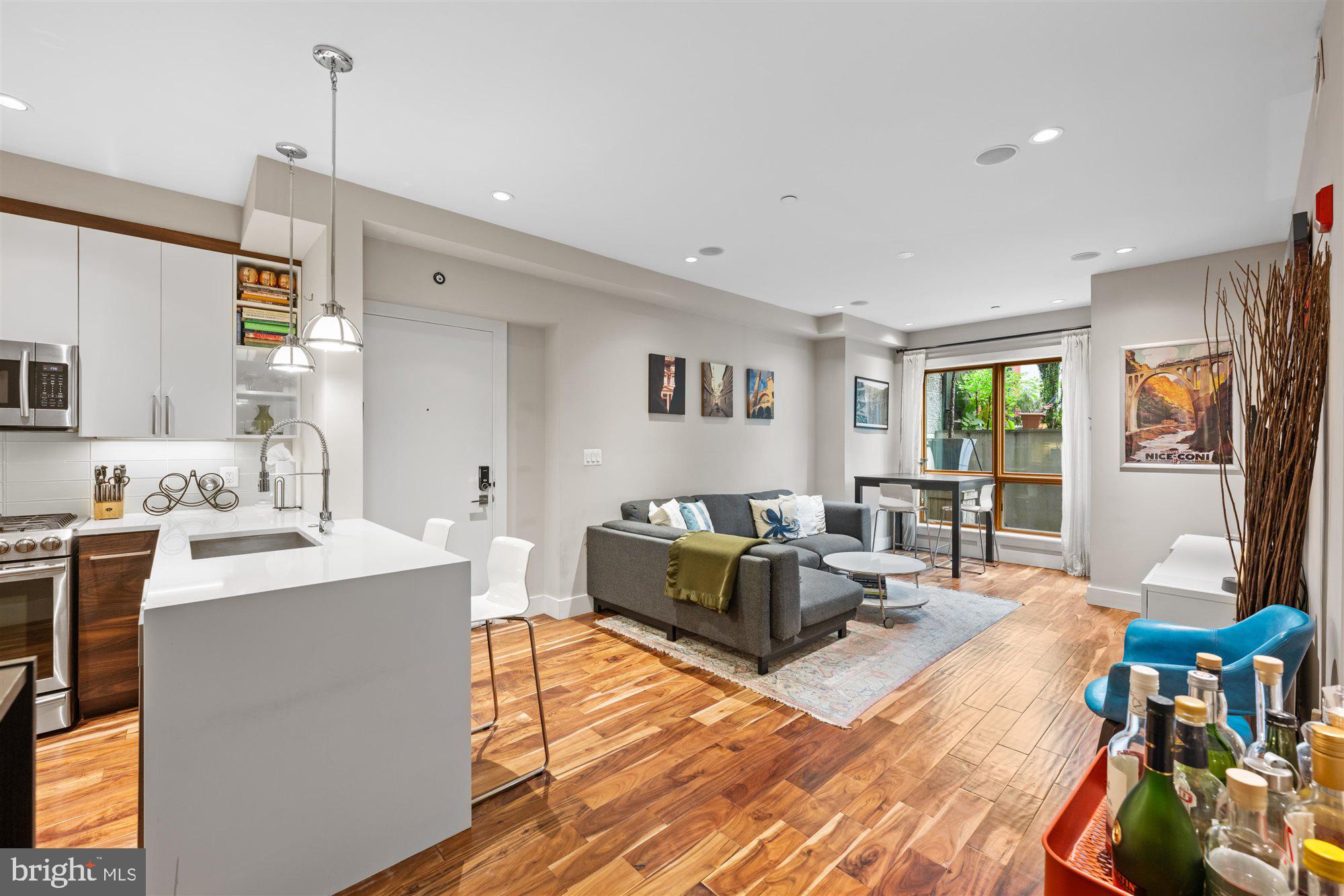 1337 K Street Southeast, Unit 101 Washington, DC 20003 - Photo 5 of 12 a living room with furniture and a wooden floor