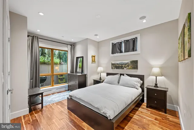 a spacious bedroom with a bed and a large window