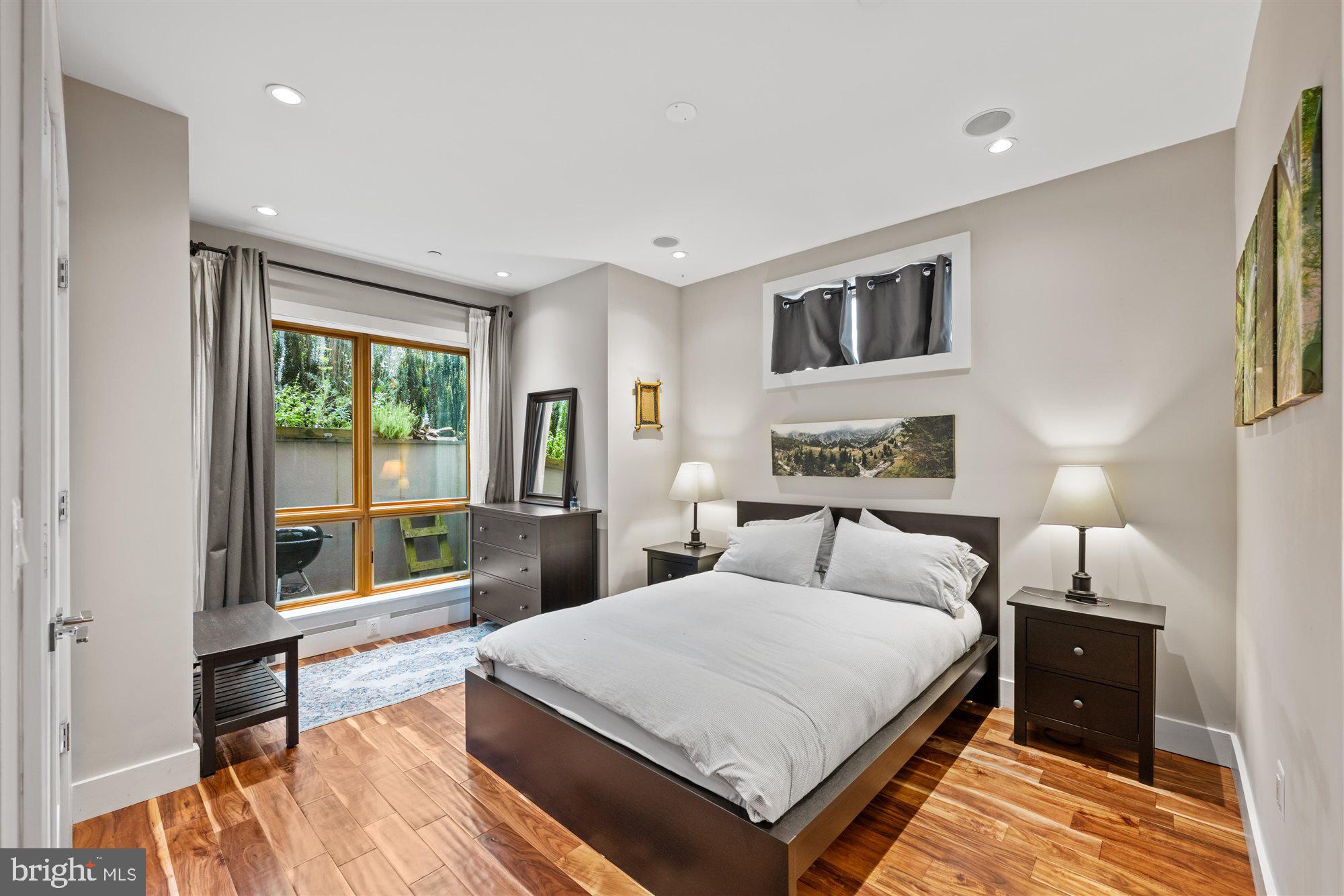 1337 K Street Southeast, Unit 101 Washington, DC 20003 - Photo 7 of 12 a spacious bedroom with a bed and a large window