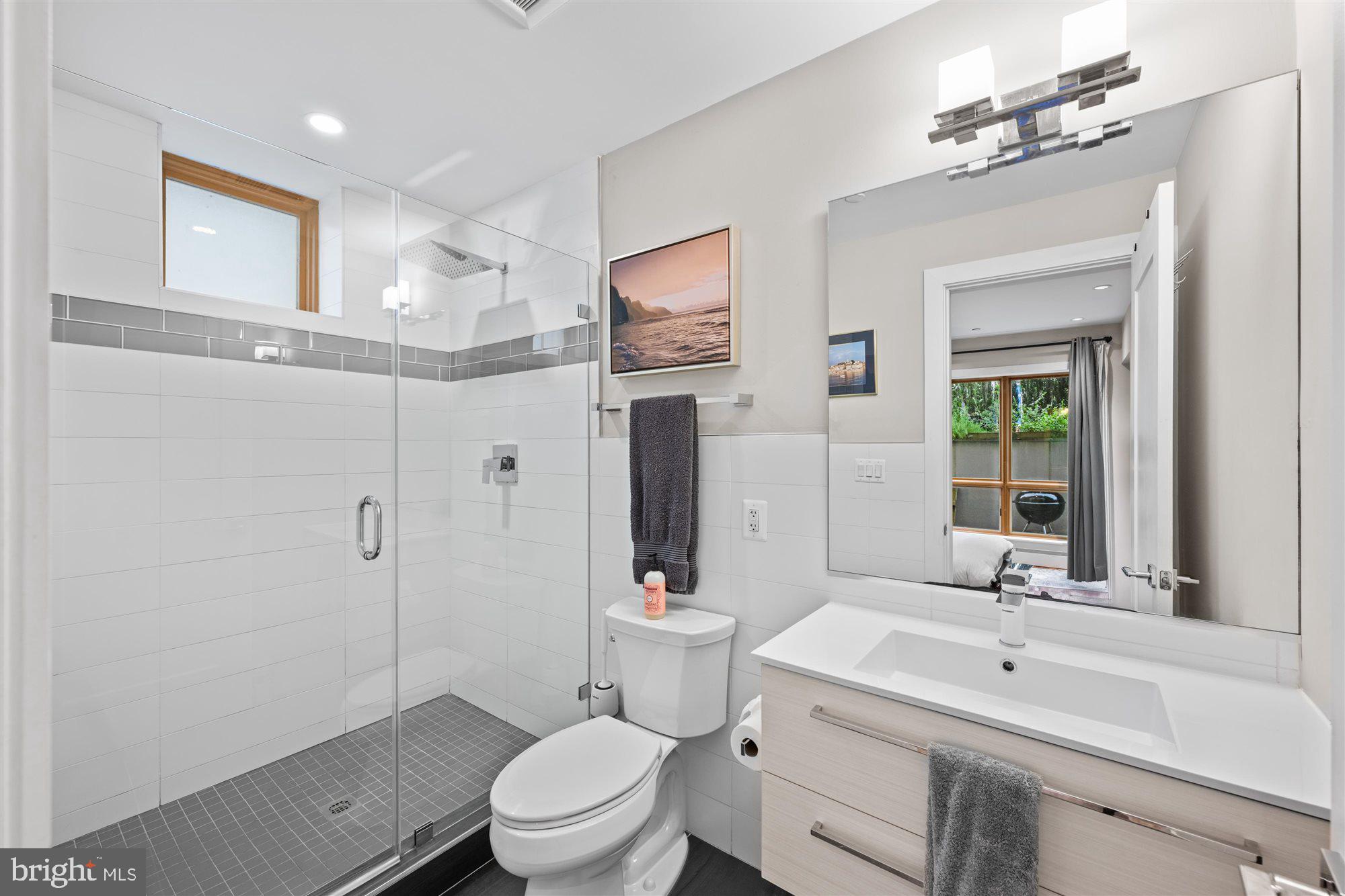 1337 K Street Southeast, Unit 101 Washington, DC 20003 - Photo 8 of 12 a bathroom with a sink a toilet and shower