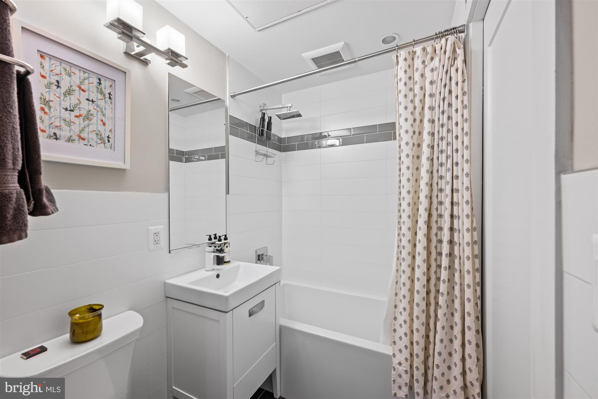 1337 K Street Southeast, Unit 101 Washington, DC 20003 - Photo 10 of 12 a bathroom with a sink a toilet and shower