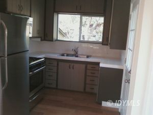 26831 Saunders Meadow Road Idyllwild, CA 92549 - Photo 3 of 8 a kitchen with a sink and a refrigerator