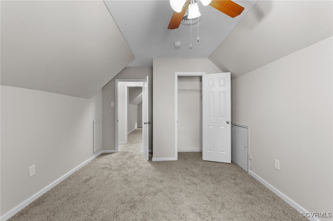 5237 Hallmark Drive Richmond, VA 23234 - Photo 23 of 44 an empty room with a chandelier fan and windows