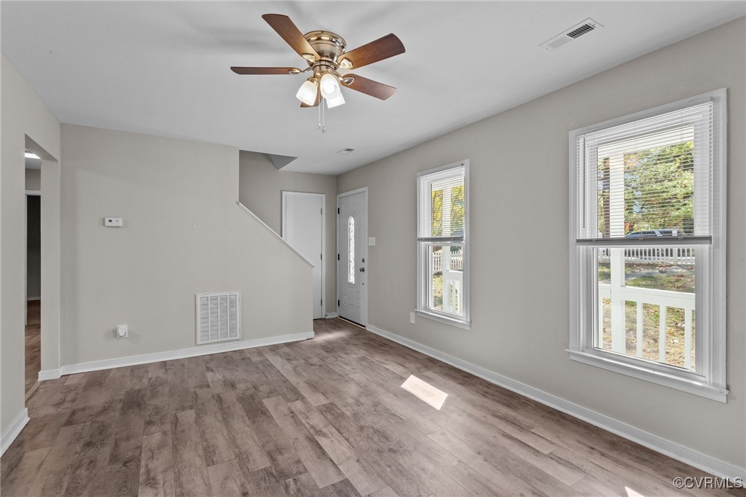 5237 Hallmark Drive Richmond, VA 23234 - Photo 5 of 44 a view of an empty room with a window and wooden floor