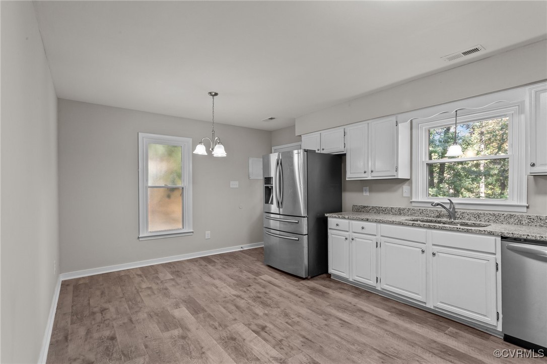 5237 Hallmark Drive Richmond, VA 23234 - Photo 6 of 44 a kitchen with a refrigerator sink and wooden floor