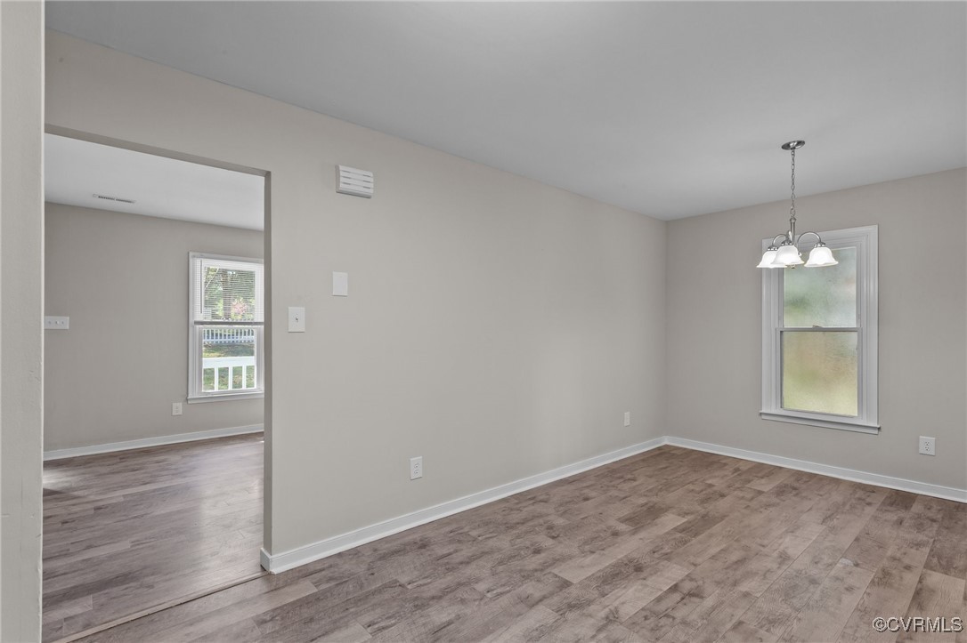 5237 Hallmark Drive Richmond, VA 23234 - Photo 7 of 44 an empty room with wooden floor and windows