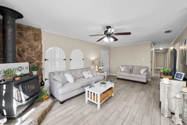 a living room with furniture and a wooden floor