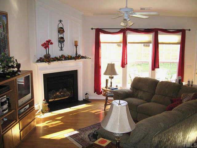 7710 Elon Drive Raleigh, NC 27613 - Photo 6 of 12 Great living room with vaulted ceiling, gas log fireplace, & five tall windows Other