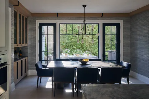 a kitchen with a table chairs stove and cabinets