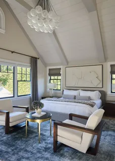 a living room with a bed furniture and a flat tv screen