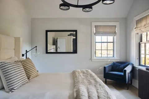 a bathroom with a sink toilet a mirror and window