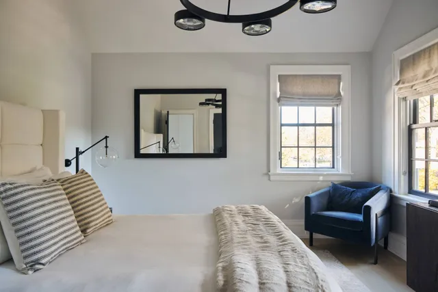 a bathroom with a sink toilet a mirror and window