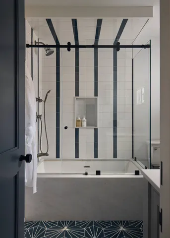 a kitchen with granite countertop a refrigerator a stove a dining table and chairs with wooden floor